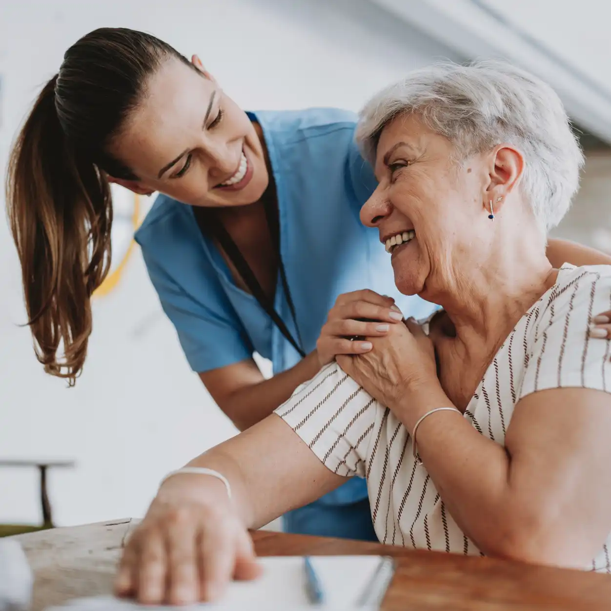 A nurse assists an elderly woman, providing care and support in a compassionate healthcare setting.
